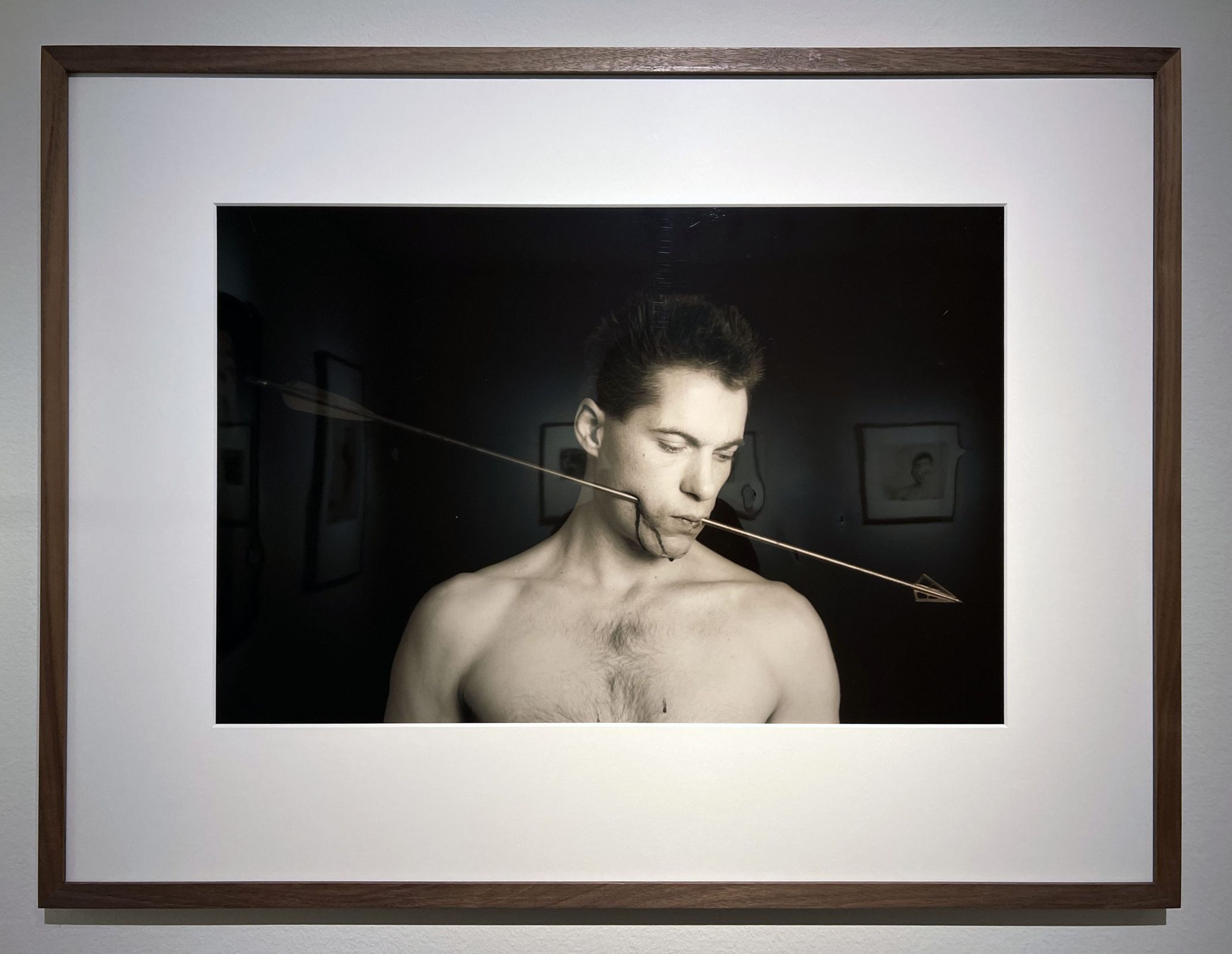 Paul Blanca, ‘Self-portrait with an arrow, 1987’, a self-portrait of himself with an arrow through his cheek. Blanca became known in the 1980s for a photo series of himself as a subject.