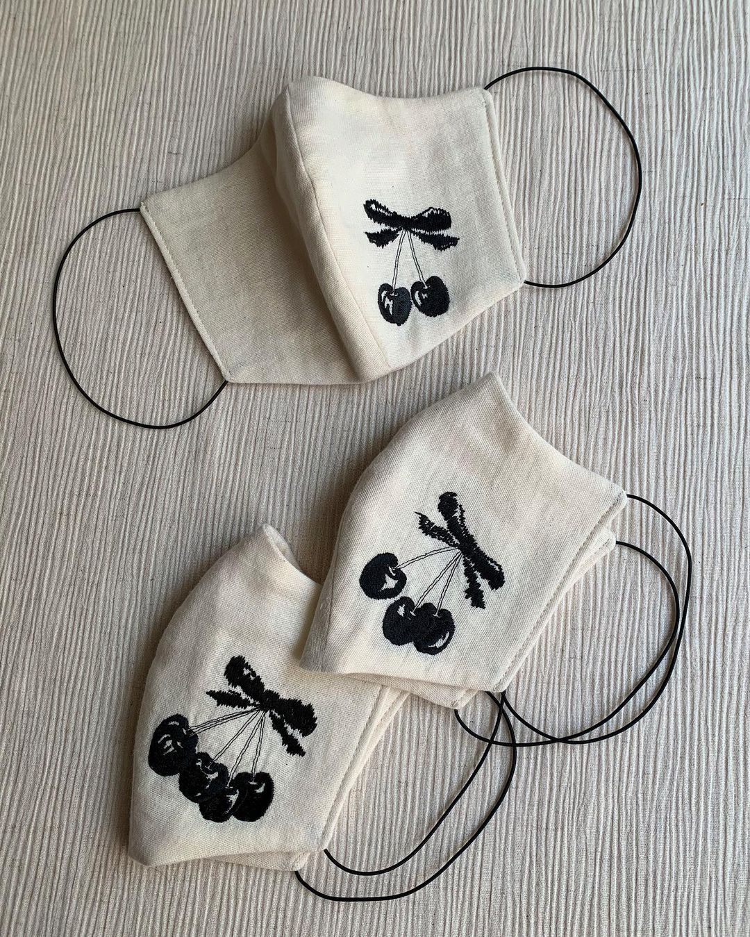 Cherry-embroidered masks that Tanaka made (from Daisuke Tanaka’s Instagram)