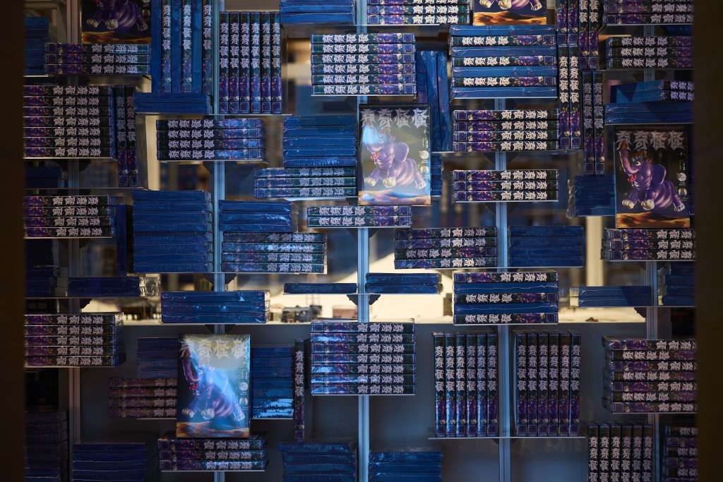 代官山蔦屋書店にて、およそ3000冊の本を積み上げた『密と圧』と題された特設展示。本が売れるにしたがって、奥に仕込まれた、アーティストのGILLOCHINDOX☆GILLOCHINDAEが手がけた作品が姿を表す仕様